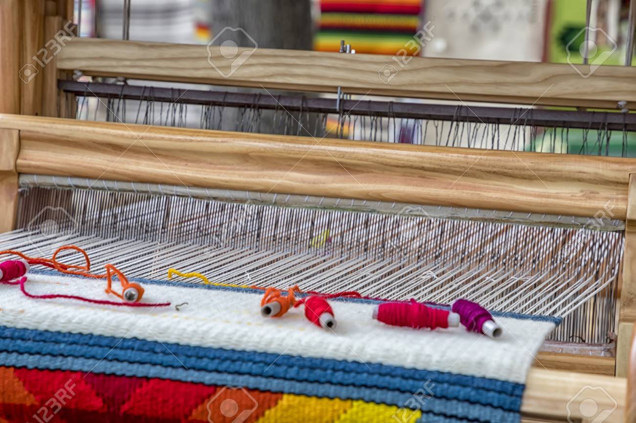 A traditional colorful vintage weaving loom and thread of yarn stock photo picture and royalty free image image