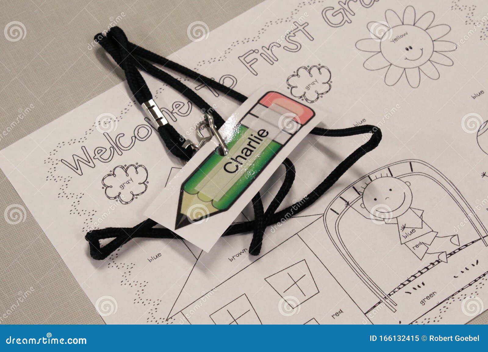 A name tag and wele coloring page await the arrival of a student editorial image